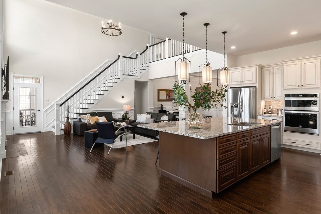 49 Pine Tree Drive, Unit 49 Methuen, MA 01844 - Photo 9 of 38 a view of kitchen with living room and wooden floor