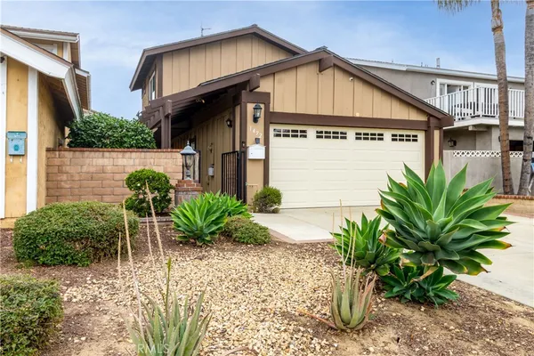 a view of a house with a small yard and plants