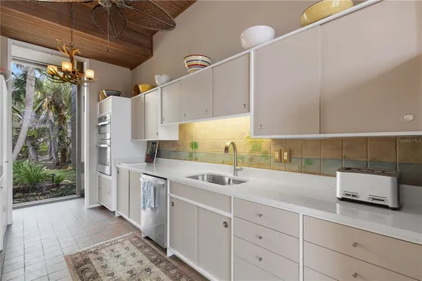 a view of a kitchen with a sink and dishwasher