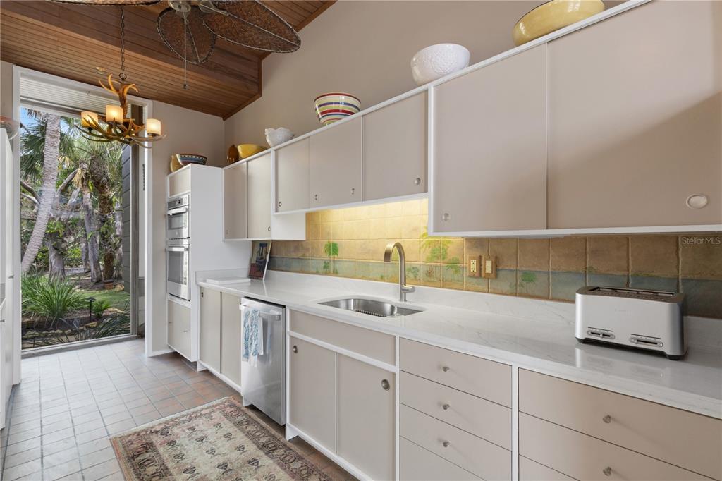 62 Sandy Hook Road South Sarasota, FL 34242 - Photo 11 of 66 a kitchen with a sink and cabinets