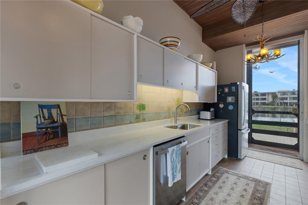 62 Sandy Hook Road South Sarasota, FL 34242 - Photo 13 of 66 a kitchen that has a sink and a stove in it