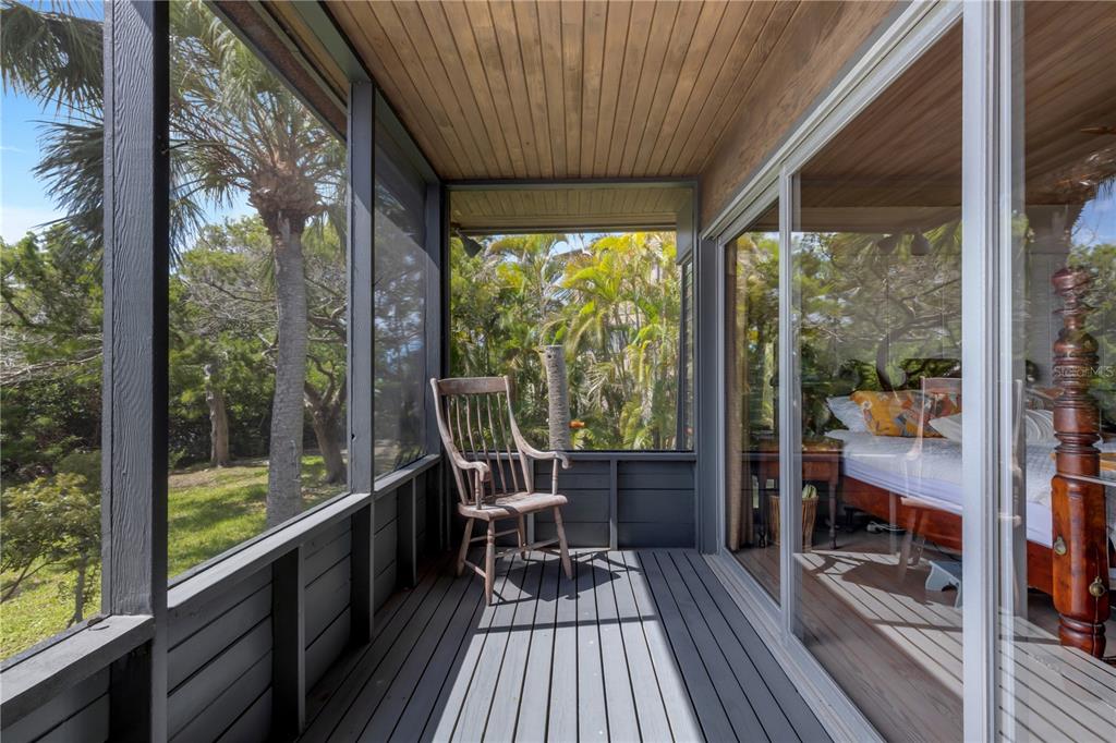 62 Sandy Hook Road South Sarasota, FL 34242 - Photo 17 of 66 a view of a balcony with chairs and wooden floor