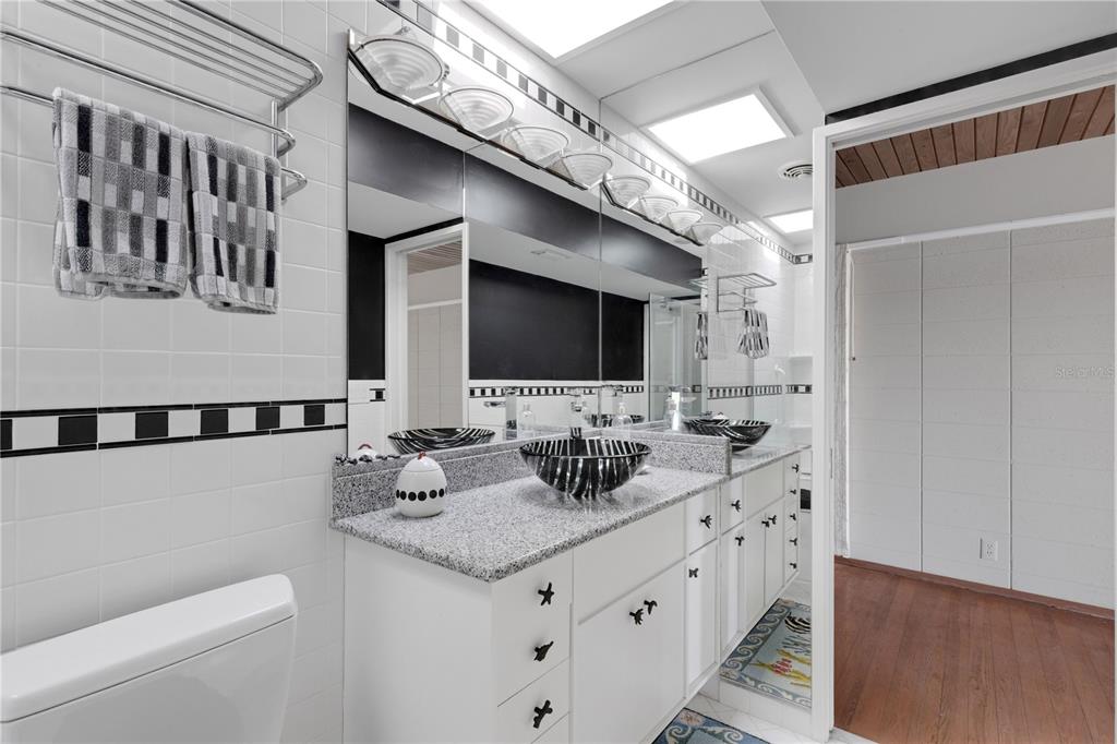 62 Sandy Hook Road South Sarasota, FL 34242 - Photo 24 of 66 a bathroom with a double vanity sink and a mirror