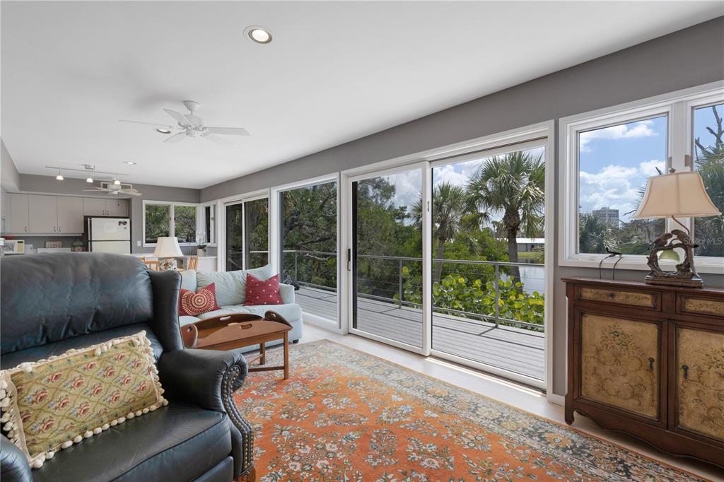 62 Sandy Hook Road South Sarasota, FL 34242 - Photo 49 of 66 a living room with furniture and a floor to ceiling window