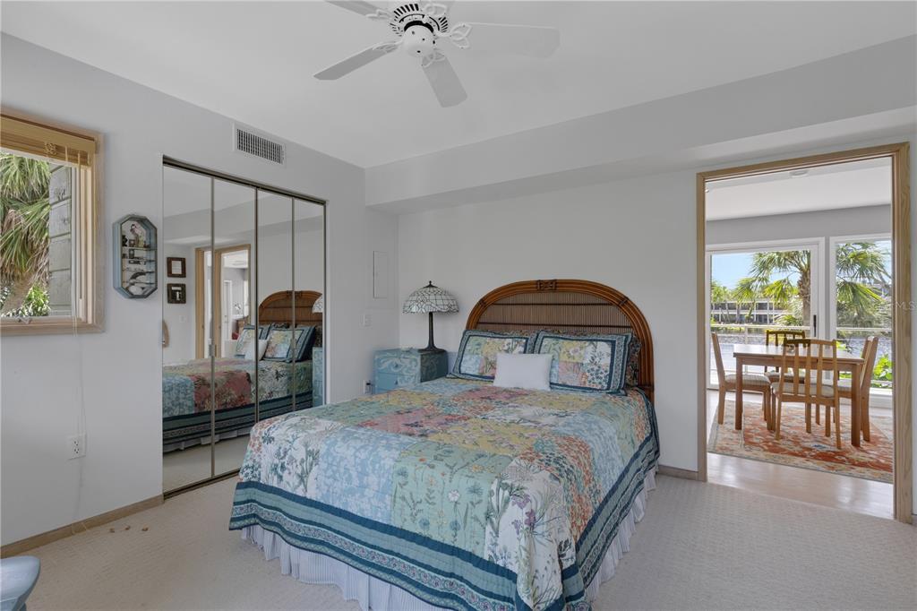 62 Sandy Hook Road South Sarasota, FL 34242 - Photo 55 of 66 a bedroom with a bed and a table