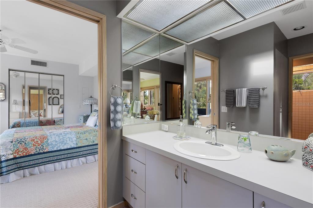 62 Sandy Hook Road South Sarasota, FL 34242 - Photo 57 of 66 a en suite bathroom with sink and mirror