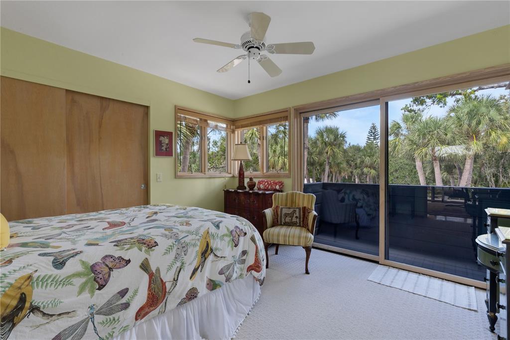 62 Sandy Hook Road South Sarasota, FL 34242 - Photo 58 of 66 a bedroom with a bed and a lamp