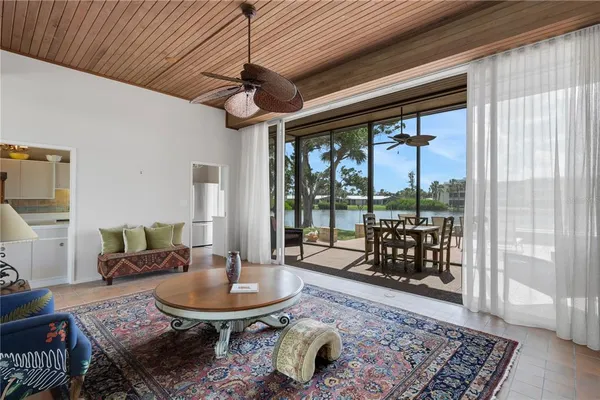 a living room with patio furniture and a rug