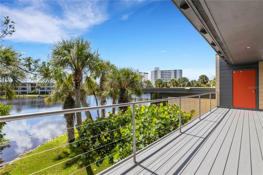 62 Sandy Hook Road South Sarasota, FL 34242 - Photo 61 of 66 a view of a balcony with wooden floor and city view