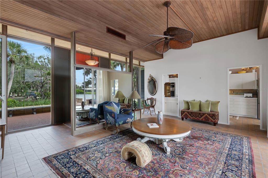 62 Sandy Hook Road South Sarasota, FL 34242 - Photo 7 of 66 a living room with furniture a rug and a floor to ceiling window