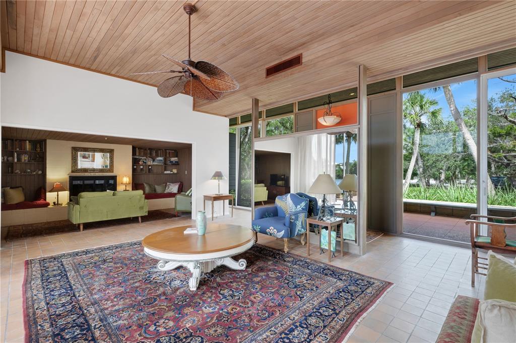 62 Sandy Hook Road South Sarasota, FL 34242 - Photo 8 of 66 a living room with patio furniture and a rug