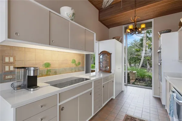 a kitchen that has a sink and a stove in it