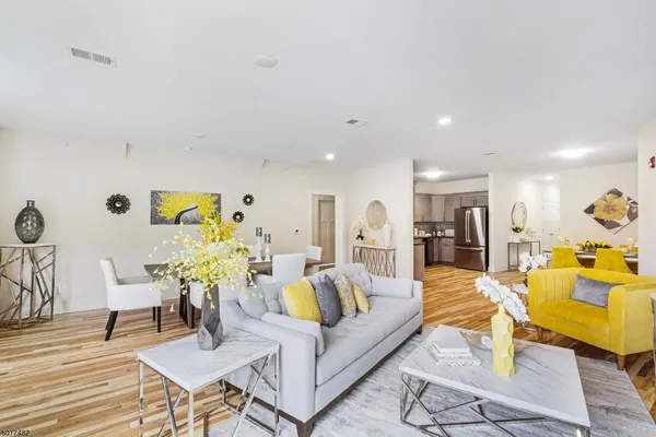 a living room with furniture and wooden floor