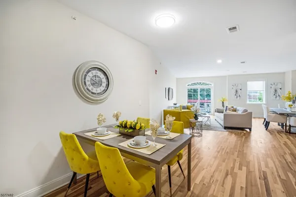a view of a dining room with furniture and wooden floor