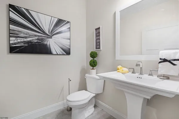 a bathroom with a sink a mirror and a toilet