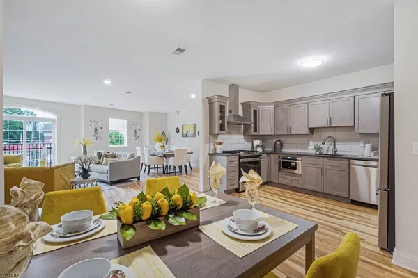 a living room with furniture kitchen and a view of kitchen