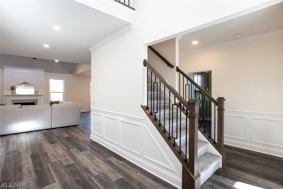 34286 Brookside Lane North Ridgeville, OH 44039 - Photo 7 of 50 Stairs featuring ornamental molding, a fireplace, recessed lighting, and wood finished floors