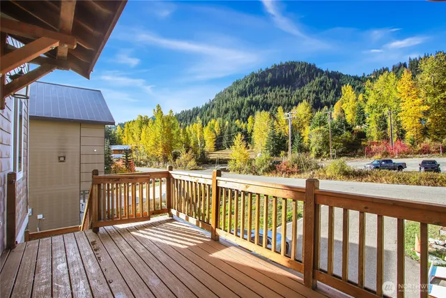 a view of balcony with wooden floor and fence