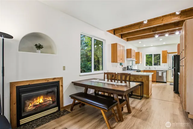 a kitchen with a table chairs and a fireplace