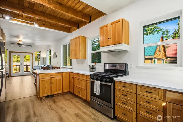a kitchen with stainless steel appliances granite countertop a stove and cabinets