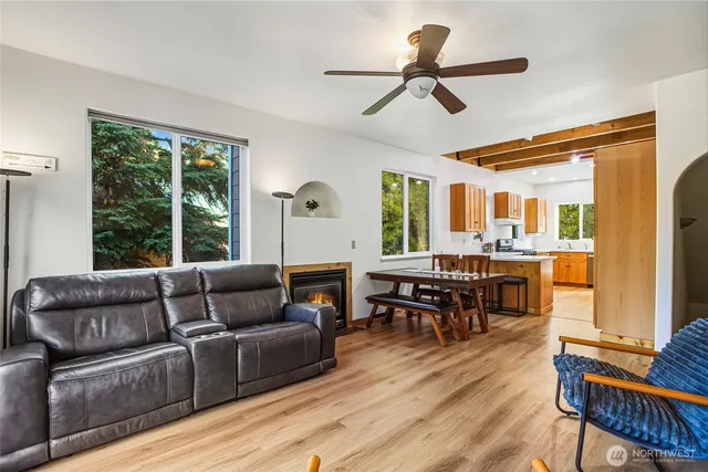 a living room with furniture wooden floor and a window