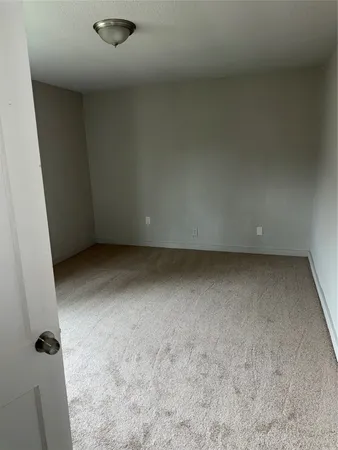 a view of an empty room with windows