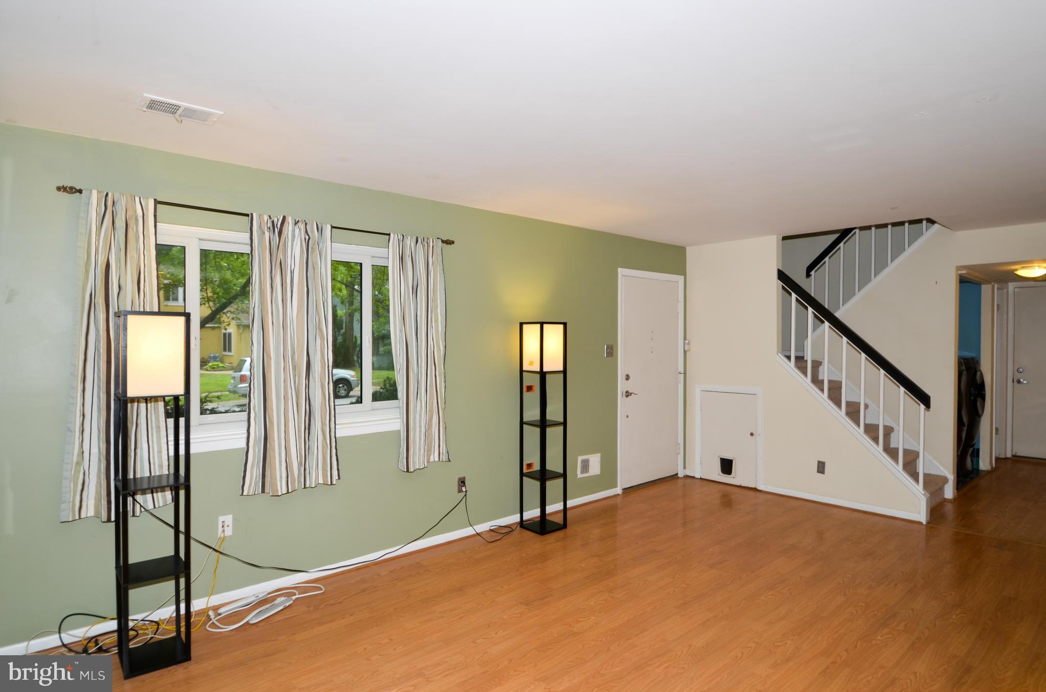 9608 Rocksparkle Row Columbia, MD 21045 - Photo 5 of 29 a view of an empty room with window and stairs