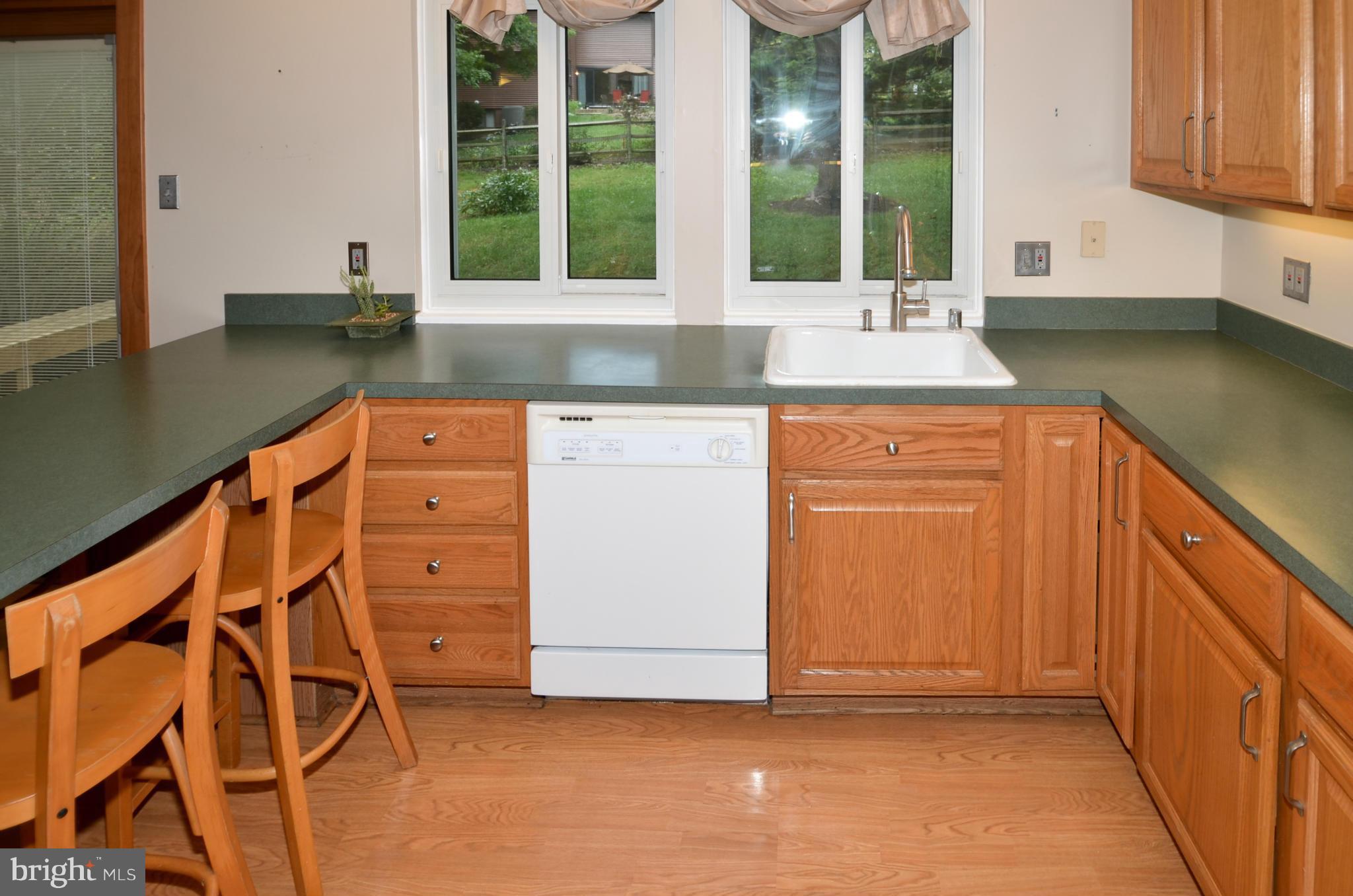 9608 Rocksparkle Row Columbia, MD 21045 - Photo 8 of 29 a kitchen with stainless steel appliances granite countertop a sink and a window