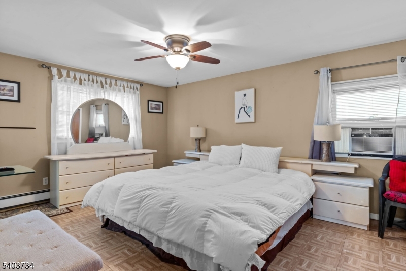 148 Locust Drive Union, NJ 07083 - Photo 11 of 34 a bedroom with a large bed and a chandelier