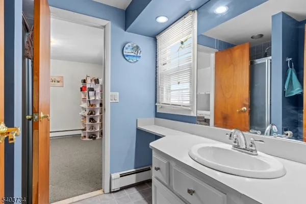 a en suite bathroom with a sink a mirror and a shower