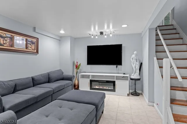 a living room with furniture fireplace and flat screen tv
