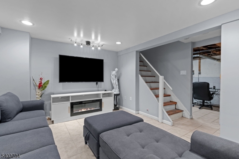 148 Locust Drive Union, NJ 07083 - Photo 20 of 34 a living room with furniture and a flat screen tv