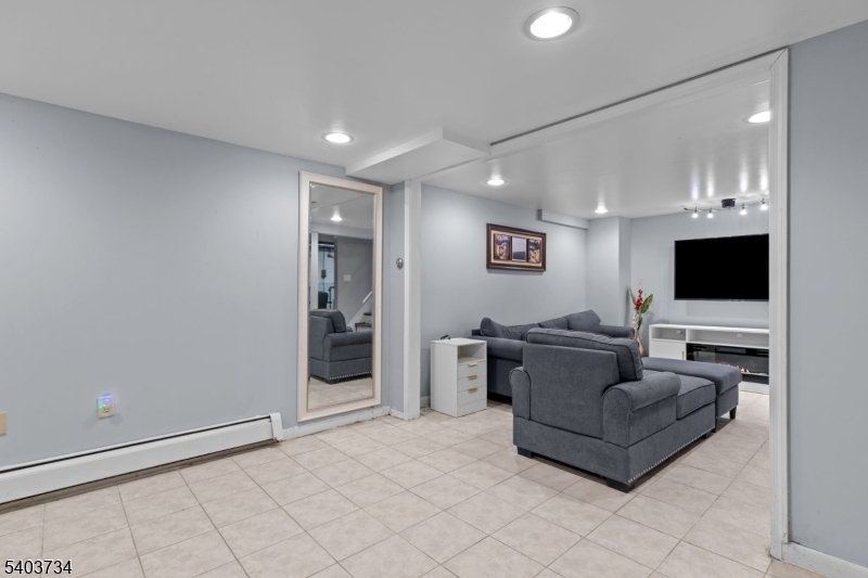 148 Locust Drive Union, NJ 07083 - Photo 24 of 34 a living room with furniture and a flat screen tv