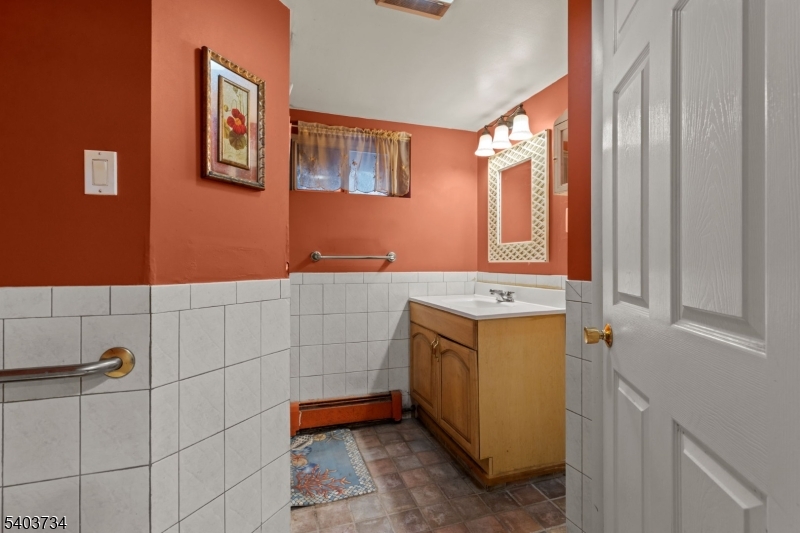 148 Locust Drive Union, NJ 07083 - Photo 25 of 34 a bathroom with a sink and mirror