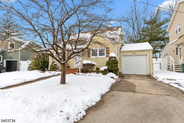 a view of a house with snow on the road