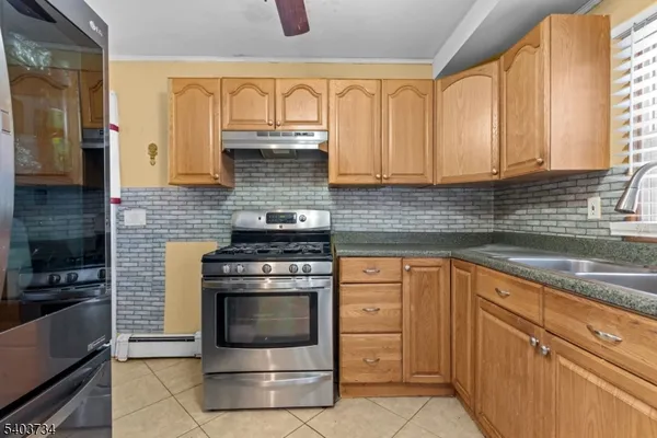 a kitchen with cabinets appliances and a sink