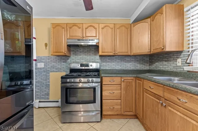 a kitchen with cabinets appliances and a sink