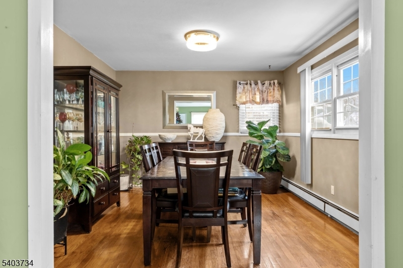 148 Locust Drive Union, NJ 07083 - Photo 9 of 34 a view of a dining room with furniture and a potted plant
