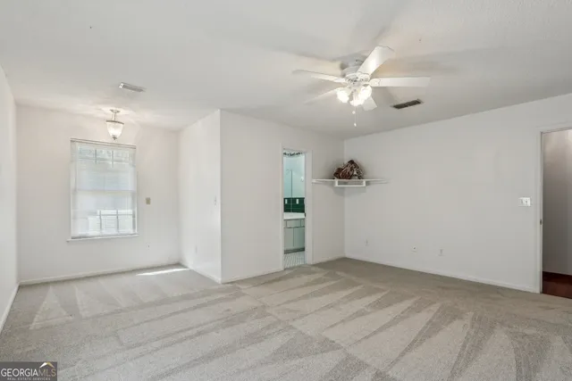 a view of room with a ceiling fan