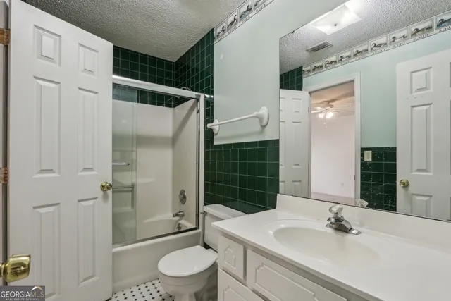 a view of a livingroom with a ceiling fan and window