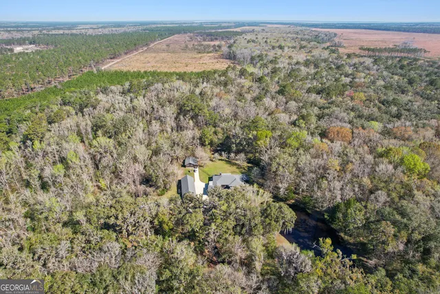 a view of a yard with wooden fence