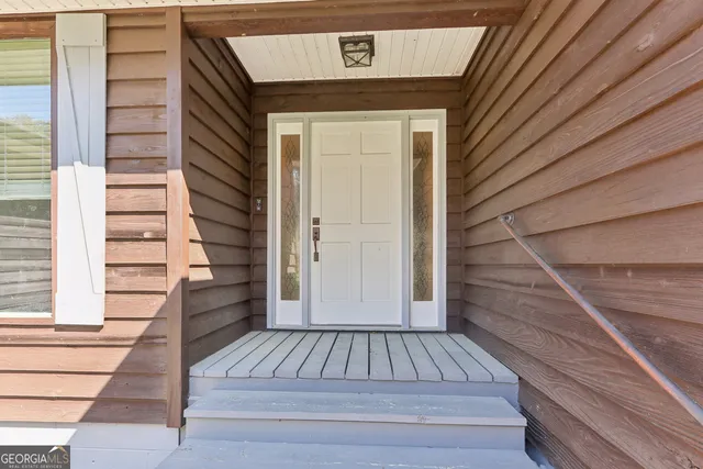 a view of wooden door and the stairs