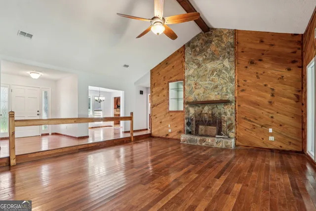 a living room with stainless steel appliances kitchen island wooden floors and view living room
