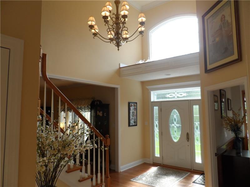 Lovely 2 story entrance showing hardwood flooring