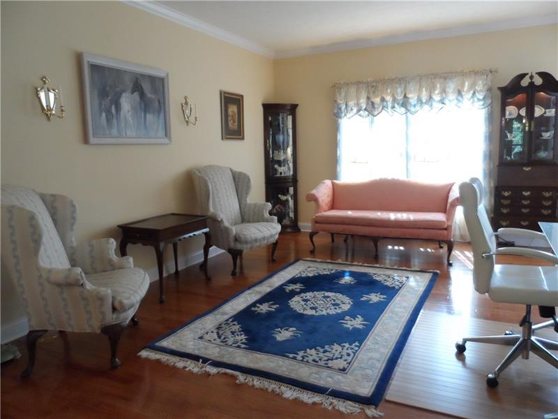 Formal Living Room, hardwood flooring accented with crown moulding