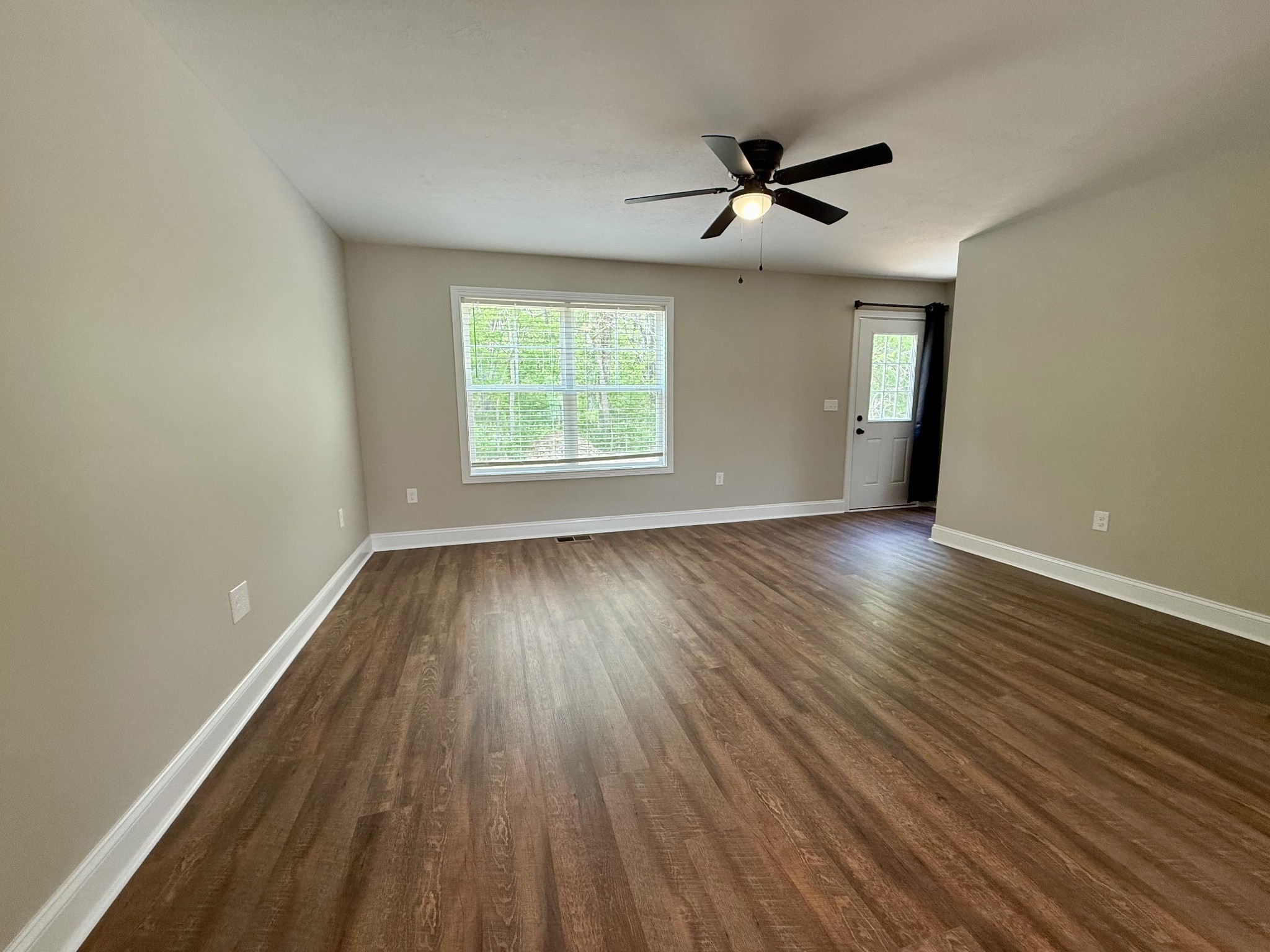 80 Ridge Road, Unit C Waverly, TN 37185 - Photo 4 of 11 wooden floor in an empty room with a window
