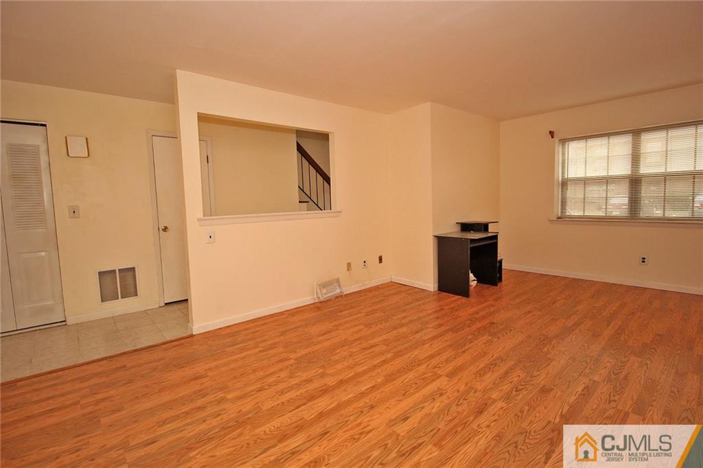 6106 Hana Road Edison, NJ 08817 - Photo 5 of 25 a view of empty room with wooden floor and fan