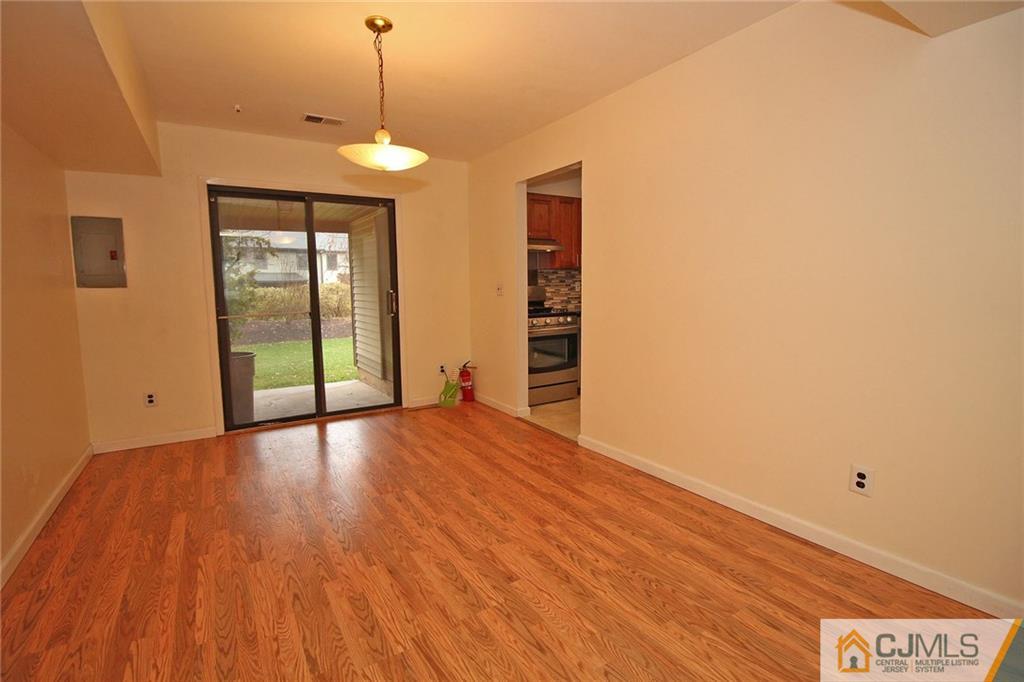 6106 Hana Road Edison, NJ 08817 - Photo 8 of 25 a view of an empty room with wooden floor and a window