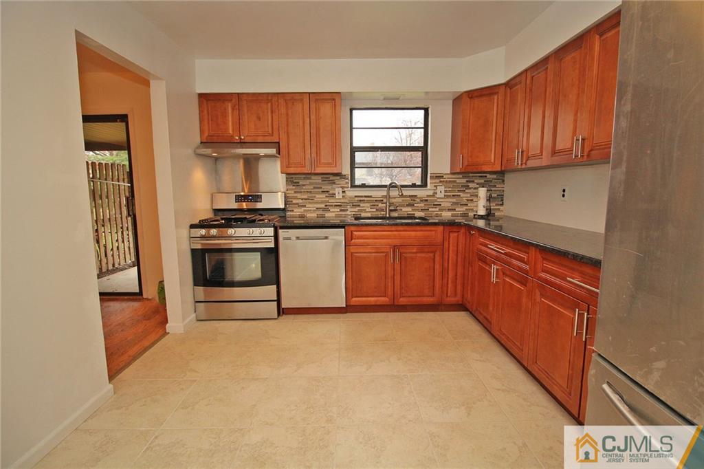 6106 Hana Road Edison, NJ 08817 - Photo 9 of 25 a kitchen with stainless steel appliances granite countertop a stove a sink dishwasher and a refrigerator