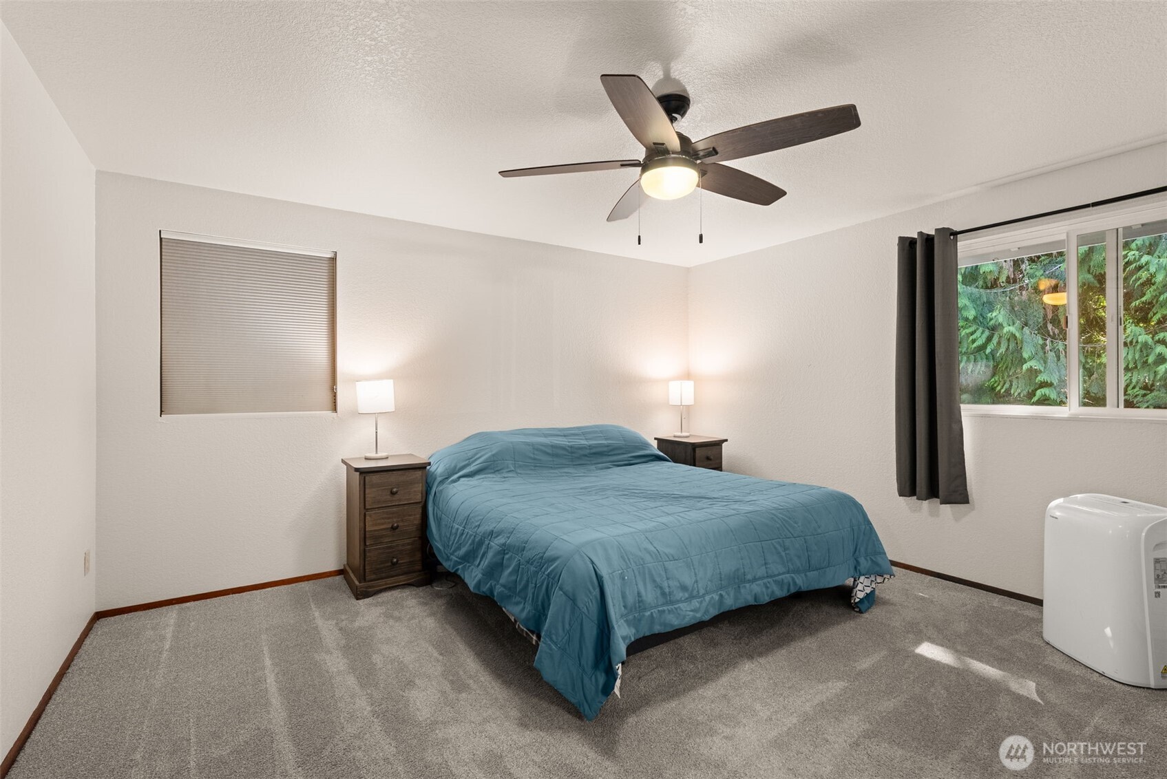 119 River Heights Road Centralia, WA 98531 - Photo 15 of 40 a spacious bedroom with a bed and a ceiling fan